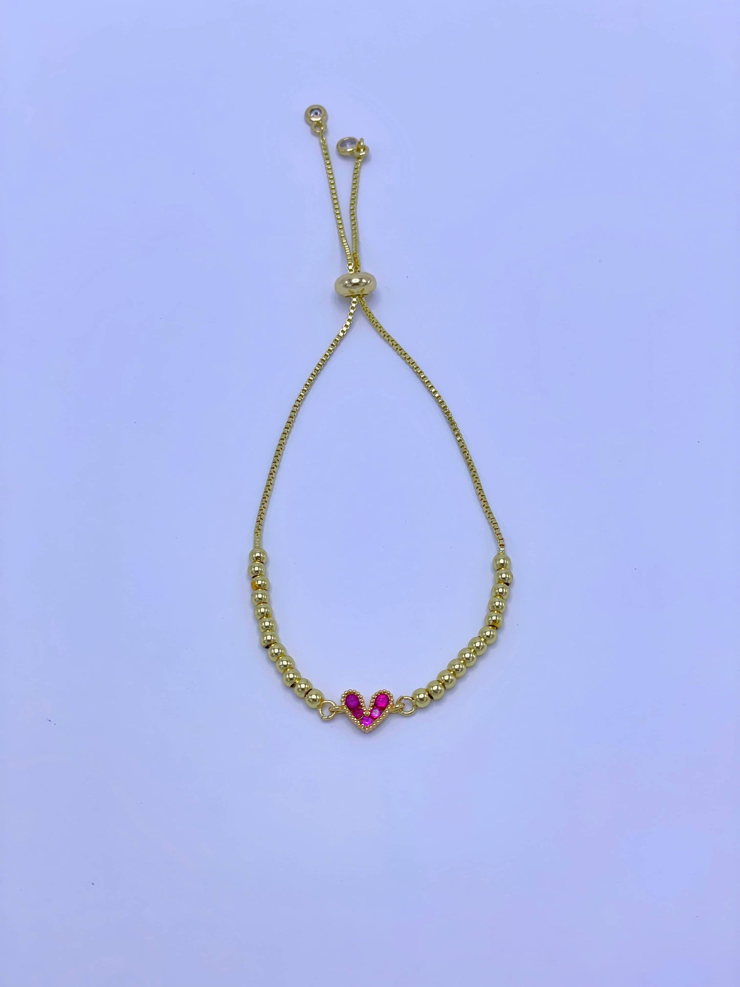 Pulsera graduable dije corazón fucsia